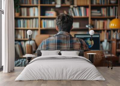 Man Studying Geography on a Computer in a Home Library Wall mural