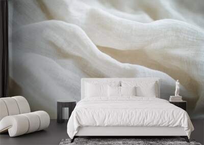 Soft white fabric gently draped and illuminated to highlight its texture and flow Wall mural