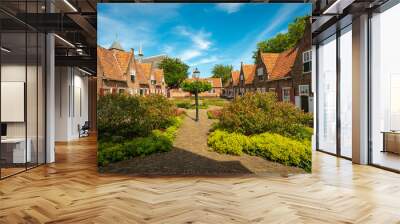 Medieval Dutch almshouses on a sunny summer day with a blue sky Wall mural