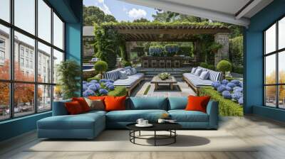 High-quality photo of an outdoor living area in a lush garden with low hedges and plants, featuring two long blue striped couches, a wooden bar table, a stone fountain, greenery around a pool, Wall mural