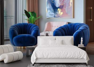 Two blue velvet swivel chairs with gold legs and brass frame, with a glass coffee table, pink chair, and artwork in a modern living room interior. Wall mural