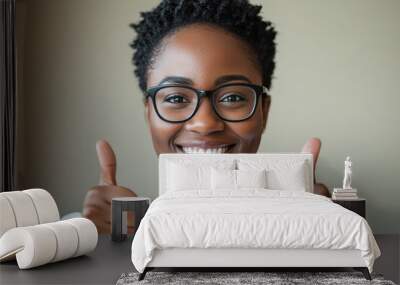 Young African American woman thumbs up in front of the camera Wall mural