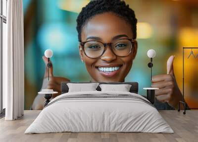 Young African American woman thumbs up in front of the camera Wall mural