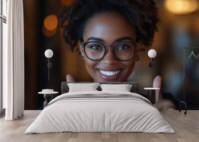 Young African American woman thumbs up in front of the camera Wall mural