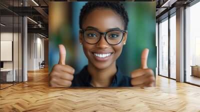 Young African American woman thumbs up in front of the camera Wall mural