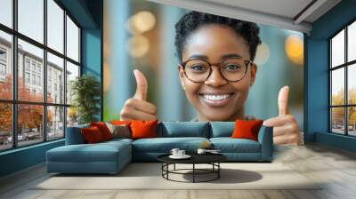 Young African American woman thumbs up in front of the camera Wall mural