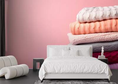 A pile of cozy sweaters in different colors Wall mural