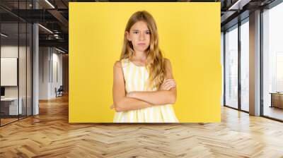 Beautiful caucasian kid girl wearing yellow dress Pointing down with fingers showing advertisement, surprised face and open mouth Wall mural