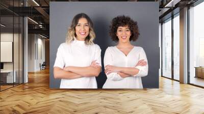 Brunette girl happy face smiling with crossed arms looking confident at the camera standing against gray wall. Positive person. Wall mural