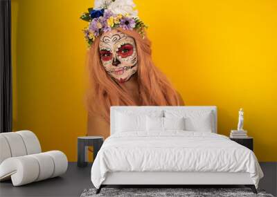 Image of cheerful pretty young caucasian woman wearing halloween make up standing indoors with arms crossed. Looking and smiling at the camera. Confident girl. Wall mural