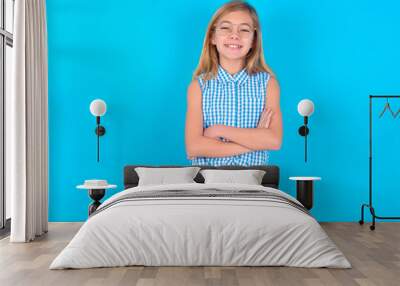 little kid girl with glasses wearing plaid shirt over blue background being happy smiling and crossed arms looking confident at the camera. Positive and confident person. Wall mural