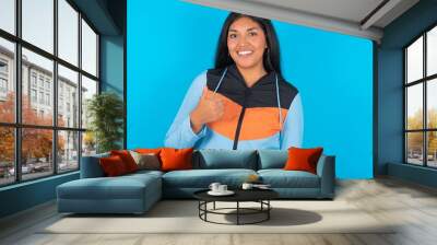 young beautiful latin woman wearing sportswear giving thumb up gesture, good Job! Positive human emotion facial expression body language. Wall mural