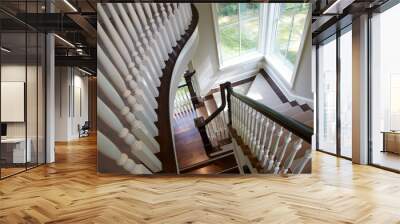 Beautiful interior curved staircase with dark wood and white spindles Wall mural