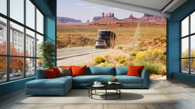 Recreational vehicle driving through Monument Valley Wall mural