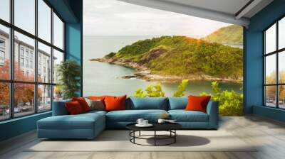 Sea with island in morning light and over light the sun Wall mural