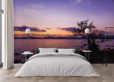 Tree in the sea with color of sunset Wall mural