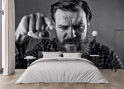 Closeup portrait of an angry bearded man threatening with his fi Wall mural