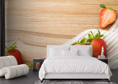 Tasty red fresh organic strawberries with napkin on wooden background. Wall mural