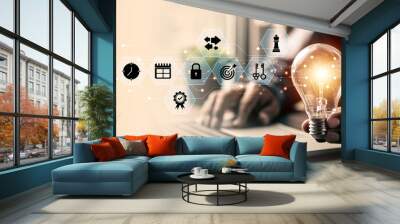 Close up hand choose light bulb or lamp for human resources or leadership and creativity thinking idea motivation or vision and knowledge learning and study or education concept. Wall mural