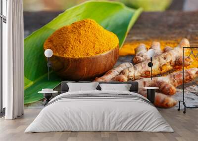 Turmeric powder in wooden bowls on wooden table Wall mural