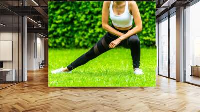 Asian woman wearing tight exercise clothes are doing exercises Wall mural