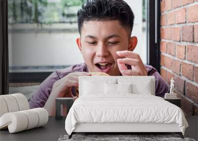 boy eating hamburger. Wall mural