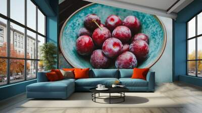 Ripe plums in bowl Wall mural