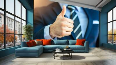 A business professional giving a thumbs up sign, symbolizing approval and success in a corporate environment. Wall mural