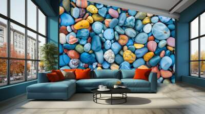 A pile of colorful rocks with a blue rock in the middle. The rocks are of different sizes and colors, creating a visually interesting and diverse scene Wall mural