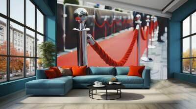 A red carpet leads into an event space with silver stanchions and velvet rope, creating a line for guests to follow Wall mural