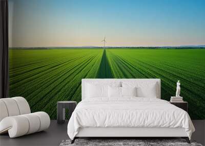 Expansive green fields with a wind turbine a symbol of renewable energy and agriculture harmony Wall mural