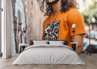 Stylish man in orange shirt, urban background. Wall mural