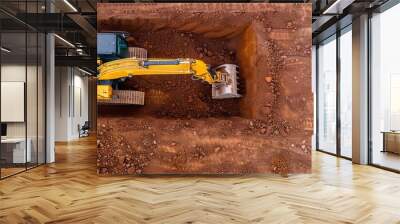 Excavator digging at a site, earthmoving equipment, groundwork Wall mural