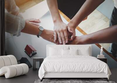 business people putting their hands together. Friends with stack of hands showing unity and teamwork Wall mural