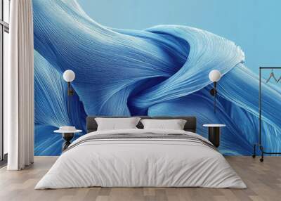 A close-up of flowing blue fabric creating elegant curves and textures against a soft blue background, evoking calm and serenity. Wall mural