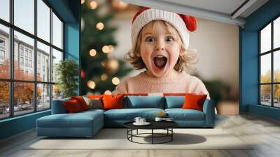 A closeup of a child s excited face as they open a Christmas gift, with a warmly lit tree in the background christmas background family warmth concept. Wall mural