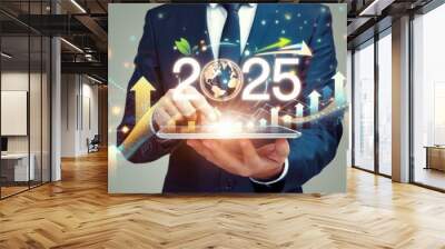 A man in a suit holding a tablet with the number 25 on it Wall mural