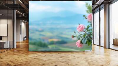 Beautiful pink roses in bloom with a scenic countryside view in the background, capturing nature's beauty and tranquility. Wall mural