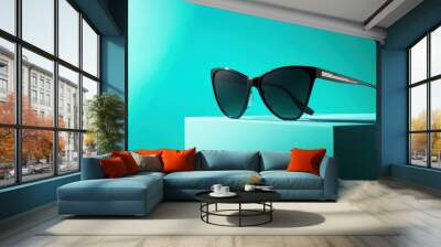 Stylish Designer Sunglasses on Bright Turquoise Background Wall mural