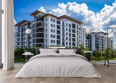 modern apartment building with blank billboard in front, surrounded by greenery Wall mural