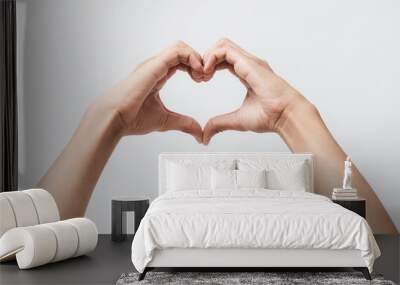 Man hands making a heart shape on a white isolated background Wall mural