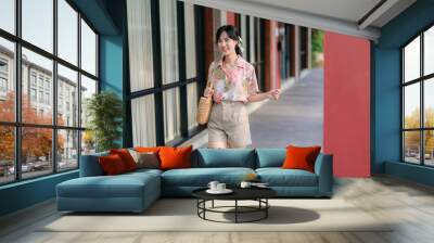 Portrait beautiful young asian woman on summer holiday vacation trip in Thailand. Young hipster female tourist sightseeing summer urban Bangkok destination. Asia summer tourism concept. Wall mural