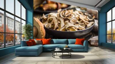 Dried porcini mushrooms. Sliced boletus on plate on wooden table. Wall mural