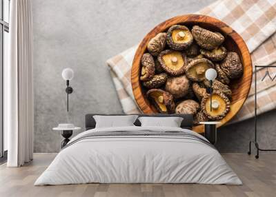 Dried shiitake mushrooms in bowl on kitchen table. Top view. Wall mural