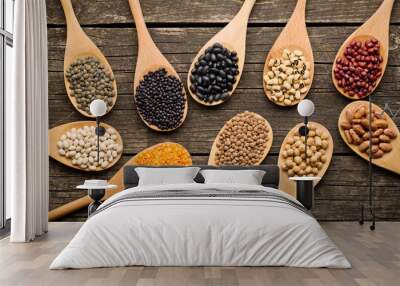 various dried legumes in wooden spoons Wall mural