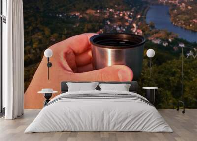 Sipping espresso from thermos over valley of european river Elbe when viewes from Mlynaruv kamen lookout in czech central mountains tourist area at sommer sunset Wall mural