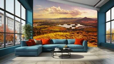 View to Zernosecke jezero lake and Lovos hill from Radobyl hill  in CHKO Ceske Stredohori tourist area at sunset  in czech summer landscape Wall mural