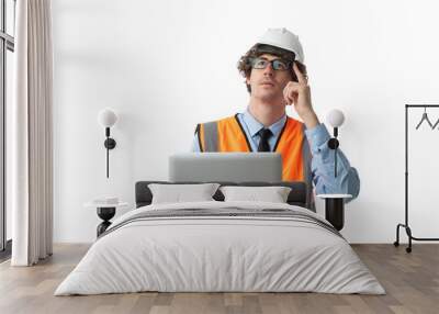 Portrait of Smiling young business man wearing orange vest and white helmet using computer laptop Wall mural