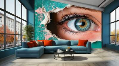 A woman's eye looking through a torn hole in vintage paper, set against a blue and beige colors mural Wall mural