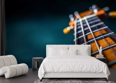 Close-up of a beautifully crafted guitar neck showcasing its detailed frets and strings against a soft, blurred background. Wall mural